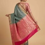 Premium semi silk Banarasi saree in sage green with contrasting pink pallu and border and delicate zari buti work