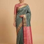 Premium semi silk Banarasi saree in sage green with contrasting pink pallu and border and delicate zari buti work