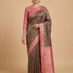 Shop Premium Semi Silk Banarasi Saree in elegant Chiku Brown with Pink contrast, delicate zari buti work and richly detailed pallu. Perfect for weddings, festivals and special occasions.