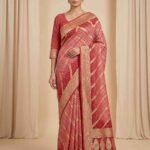 Premium cotton Bandhej Banarasi saree in peach colour with beautiful Bandhani work, multicolour motifs and intricate zari border and pallu.