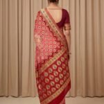 Premium cotton Bandhej Banarasi saree in peach colour with beautiful Bandhani work, multicolour motifs and zari border