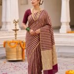 Premium Munga Silk Banarasi saree in maroon and gold with elegant zari stripe work and rich traditional border and pallu
