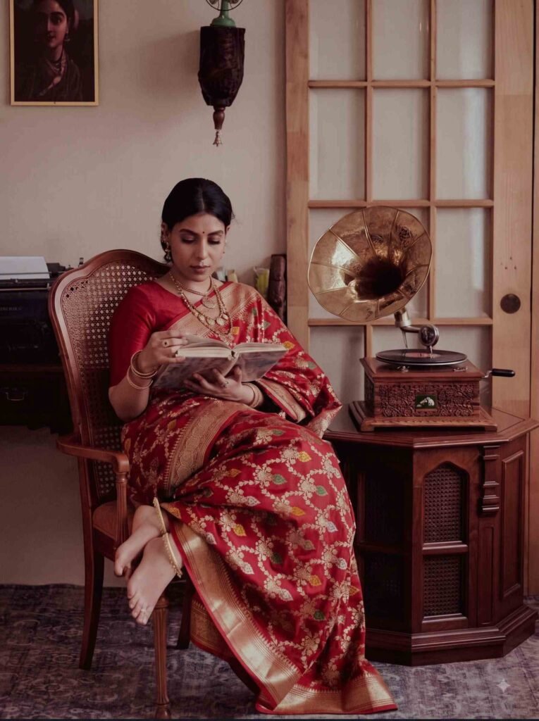 Premium handwoven Kataan Silk Banarasi saree in maroon with floral Meenakari work and intricate zari border and pallu