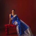 Premium handwoven Kataan Silk Banarasi saree in royal blue with colourful floral Meenakari work, intricate zari border and detailed pallu