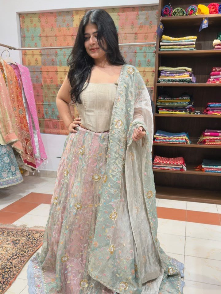 Shop Premium Customised Olive Green Banarasi Tissue Silk Lehenga with sequin, patchwork, Resham embroidery and Tikri work, paired with a matching tissue silk dupatta. Perfect for weddings and mehendi.