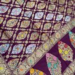 Premium handwoven Kataan Silk Banarasi saree in purple wine colour with floral Meenakari brocade work and detailed zari border and pallu