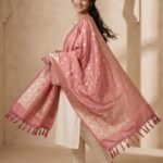 Baby pink Semi Kataan Silk Banarasi dupatta with golden zari floral jaal work, an intricate traditional border and decorative pink tassels.