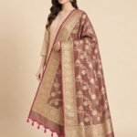 Premium chiku Semi Kataan Silk Banarasi dupatta with golden zari floral jaal work, an ornate woven border and contrasting pink tassels.