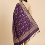 Premium deep purple Semi Kataan Silk Banarasi dupatta with golden zari floral jaal motifs, an intricate woven border and decorative tassels.