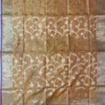 Premium mustard Semi Kataan Silk Banarasi dupatta featuring golden zari floral jaal work, an ornate zari border, pink edging and decorative tassels.