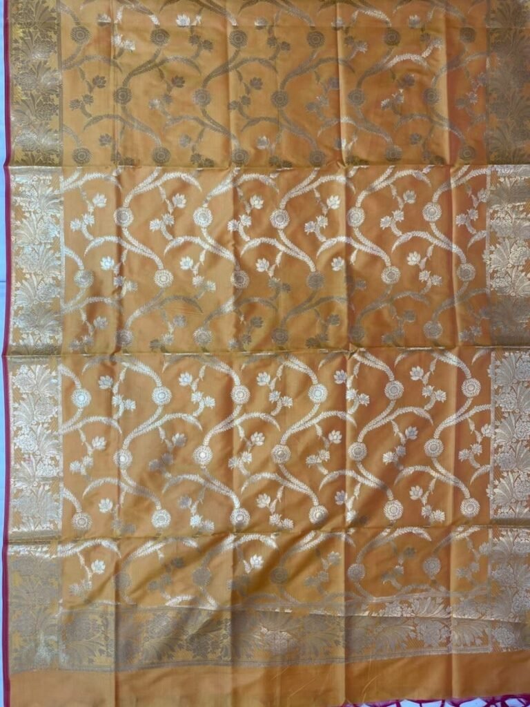 Premium mustard Semi Kataan Silk Banarasi dupatta featuring golden zari floral jaal work, an ornate zari border, pink edging and decorative tassels.