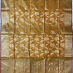 Premium mustard Semi Kataan Silk Banarasi dupatta with golden zari floral jaal work, an ornate oval-motif border and pink tassels.