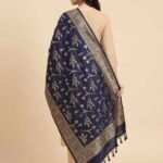Premium navy blue Semi Kataan Silk Banarasi dupatta with golden zari floral jaal motifs, an intricate woven border and decorative tassels.