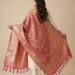 Premium peach Semi Kataan Silk Banarasi dupatta featuring golden zari floral jaal work, an ornate border and decorative pink tassels.
