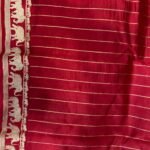 Premium green Banarasi saree with golden zari buti motifs, magenta border, traditional elephant designs and geometric pallu.