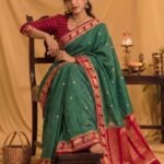 Premium green Banarasi saree with golden zari buti motifs, magenta border, traditional elephant designs and geometric pallu.