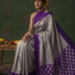 Premium tissue silk pure Banarasi saree in silver grey with zigzag zari pattern, purple Chiniya border and silver zari motifs on pallu