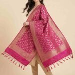 Premium rani pink Semi Kataan Silk Banarasi dupatta with all-over golden zari floral jaal work, an ornate zari border and matching pink tassels.