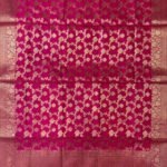 Premium rani pink Semi Kataan Silk Banarasi dupatta with all-over golden zari floral jaal work, an ornate zari border and matching pink tassels.