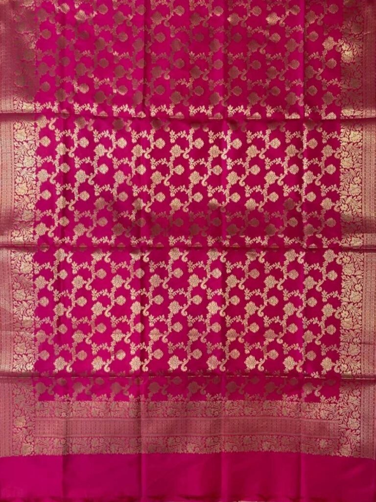 Premium rani pink Semi Kataan Silk Banarasi dupatta with all-over golden zari floral jaal work, an ornate zari border and matching pink tassels.