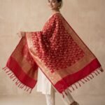Premium red Semi Kataan Silk Banarasi dupatta with golden zari floral jaal work, ornate woven borders and decorative tassels.