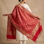 Premium red Semi Kataan Silk Banarasi dupatta with golden zari floral jaal work, ornate woven borders and decorative tassels.
