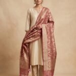 Premium rose pink Semi Kataan Silk Banarasi dupatta featuring golden zari floral jaal work, an ornate zari border and pink tassels.