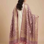 Premium wine Semi Kataan Silk Banarasi dupatta with golden zari floral jaal work, an ornate gold border and magenta-pink tassels.